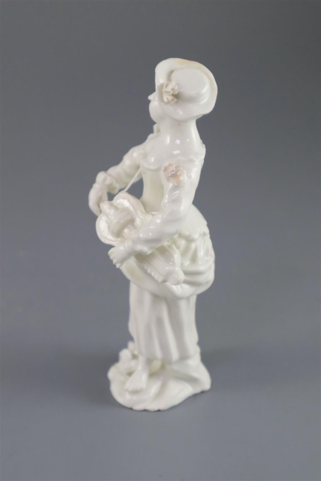 A rare French porcelain figure of a lady playing the Hurdy Gurdy, probably Orleans, c.1756-58, 13cm high